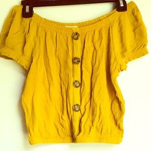 Yellow top. Off the shoulder.